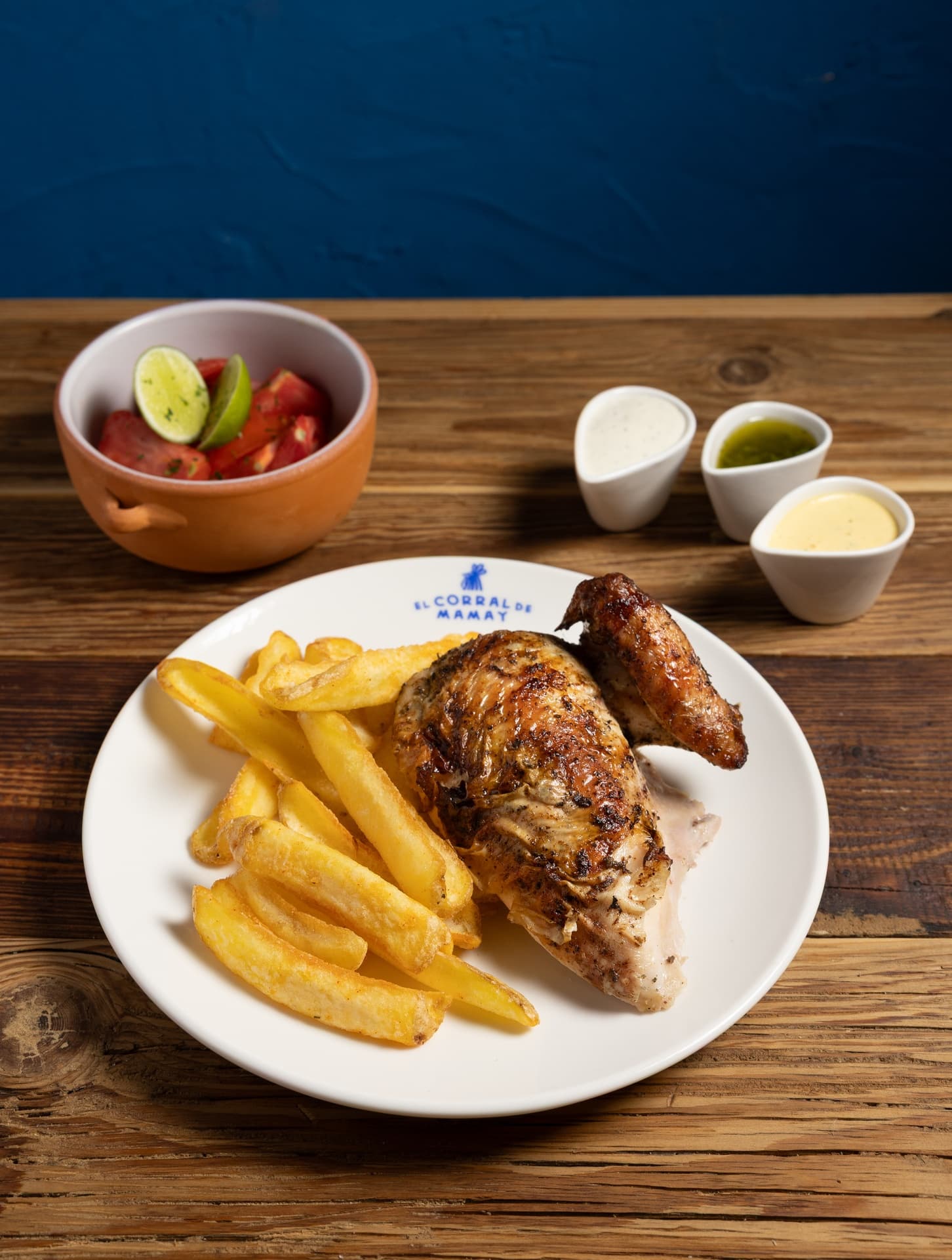 Cuarto de pollo (pechuga) a la brasa, marinado con especias peruanas, acompañado de patatas, 2 salsas y ensalada a elegir (clásica o tomate) - El Corral de Mamay